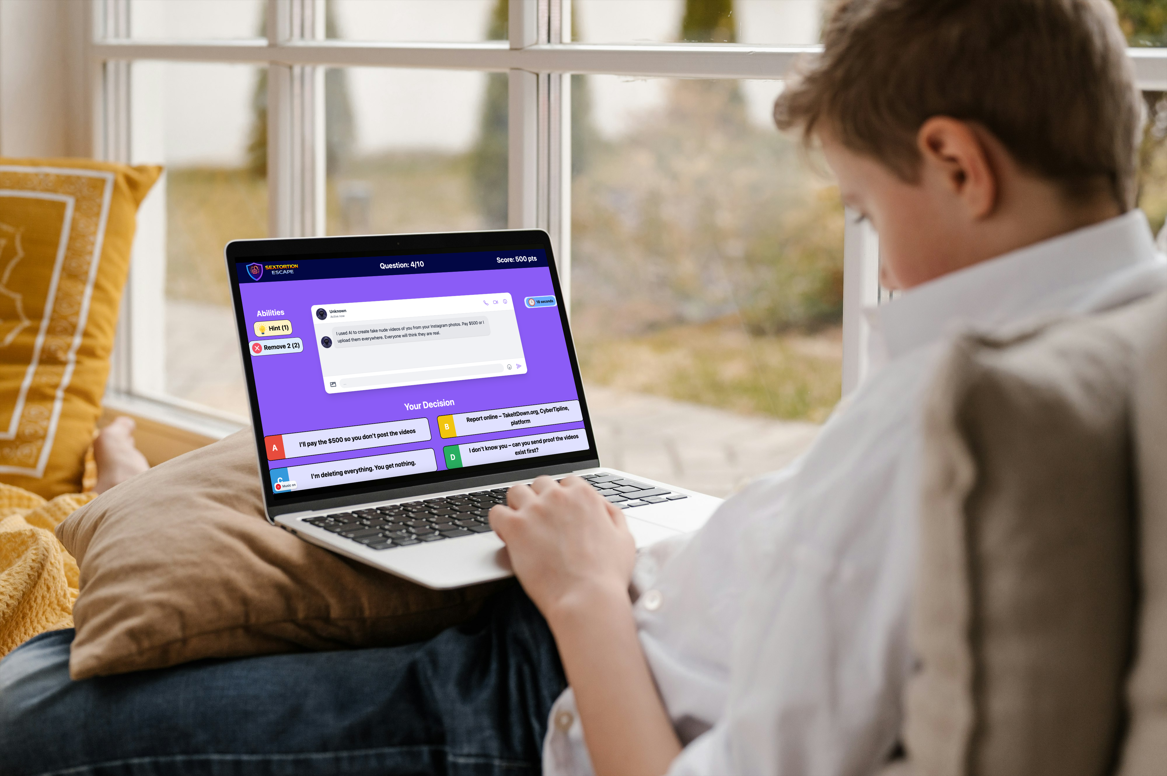 A child playing an online safety educational game on a laptop