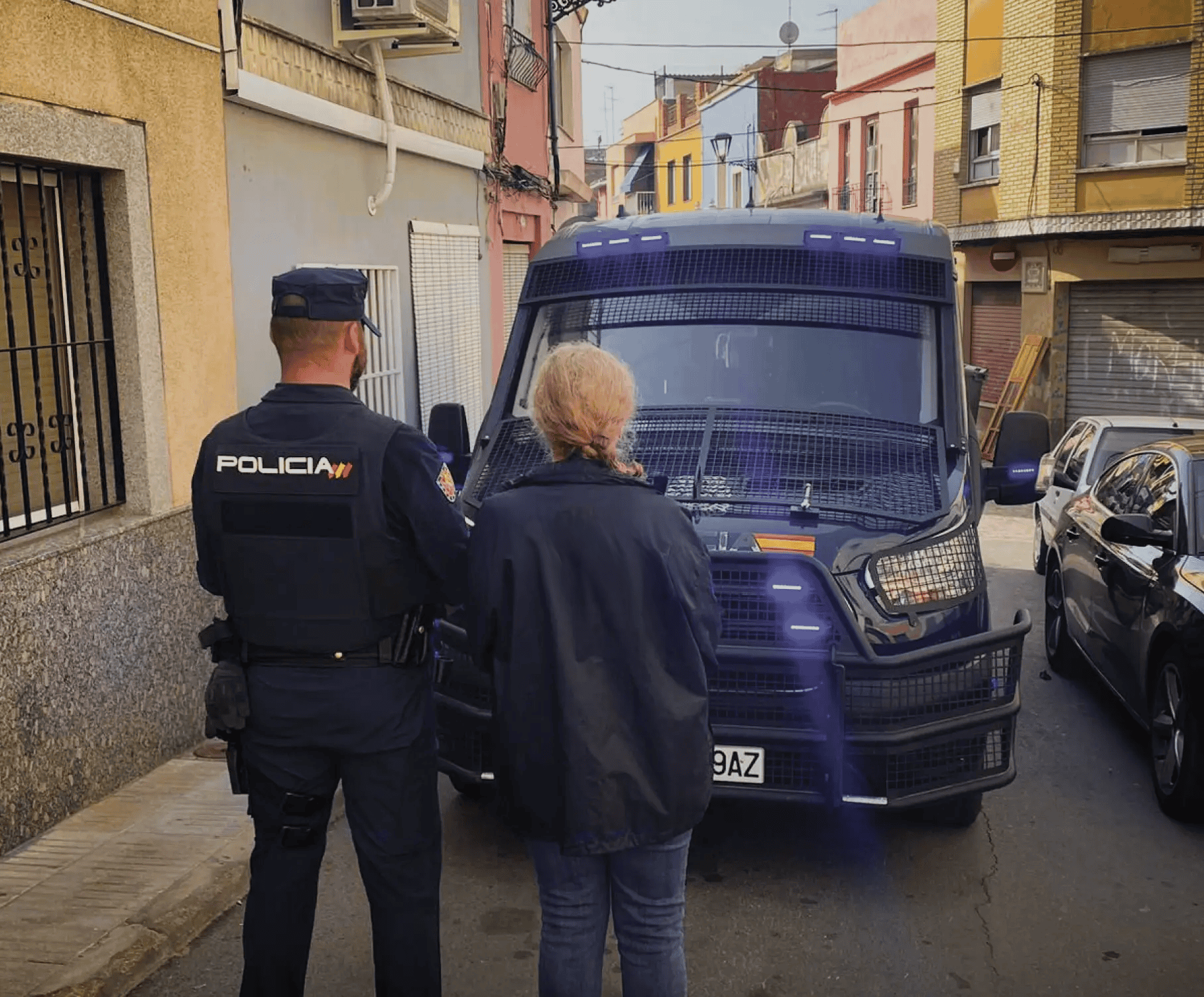 An Our Rescue Operations responder stands next to Policia