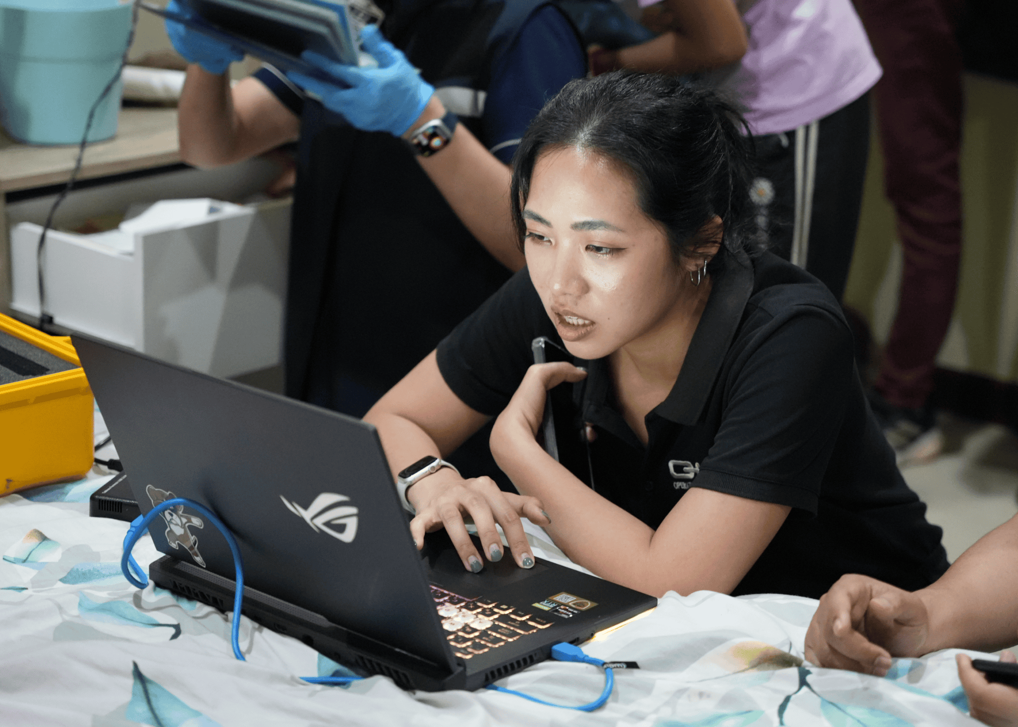 A group of operators goes over laptops and cell phones